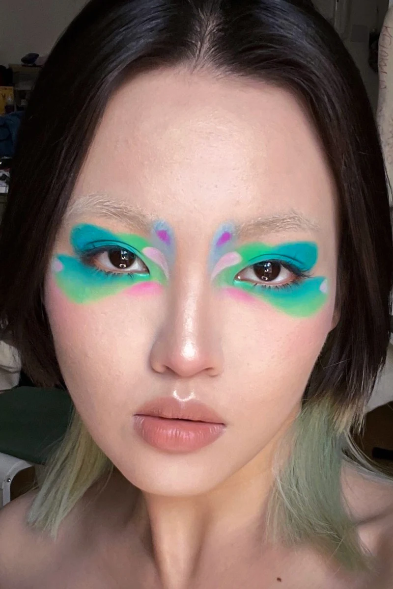 selfie of a beautiful woman with colorful graphic eyeliner look